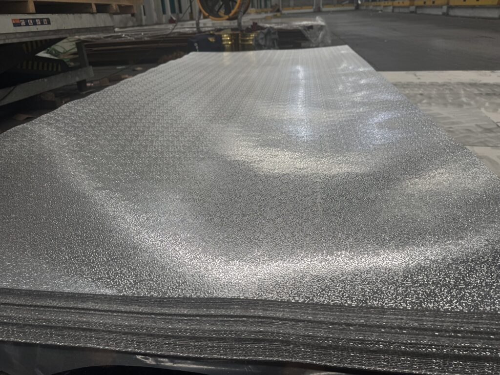 Aluminum honeycomb sandwich panel with textured aluminum surface for truck bodies and lightweight vehicle applications
