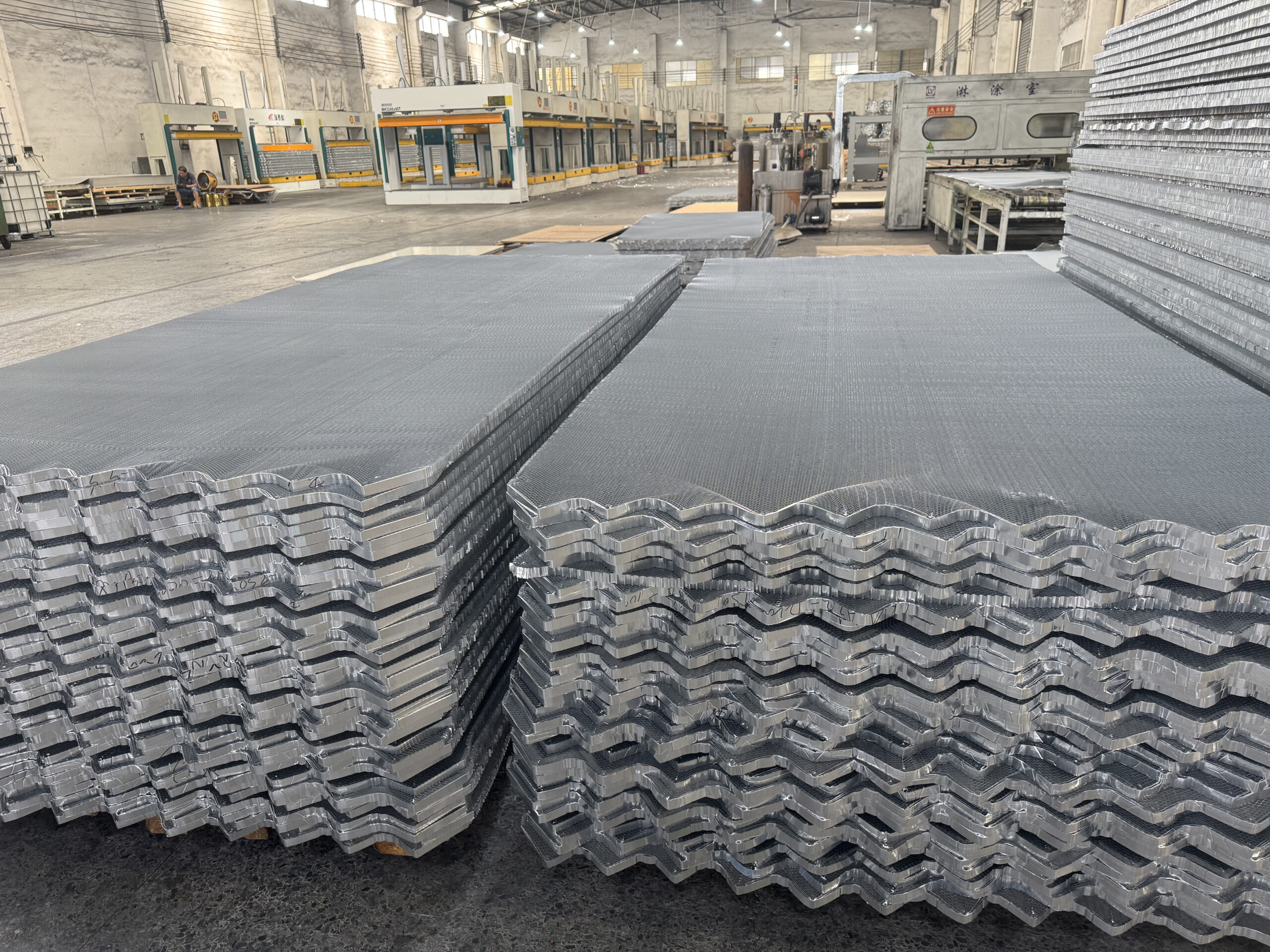 Aluminum honeycomb core sheets stacked inside a manufacturing workshop