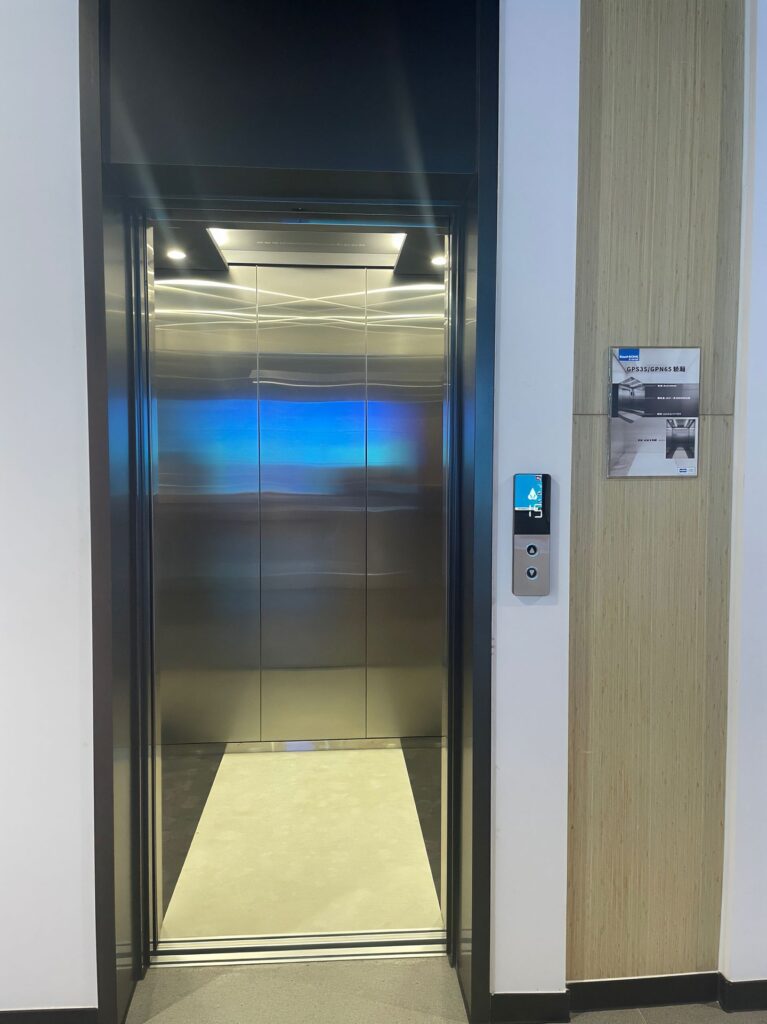 Elevator cladding panel application